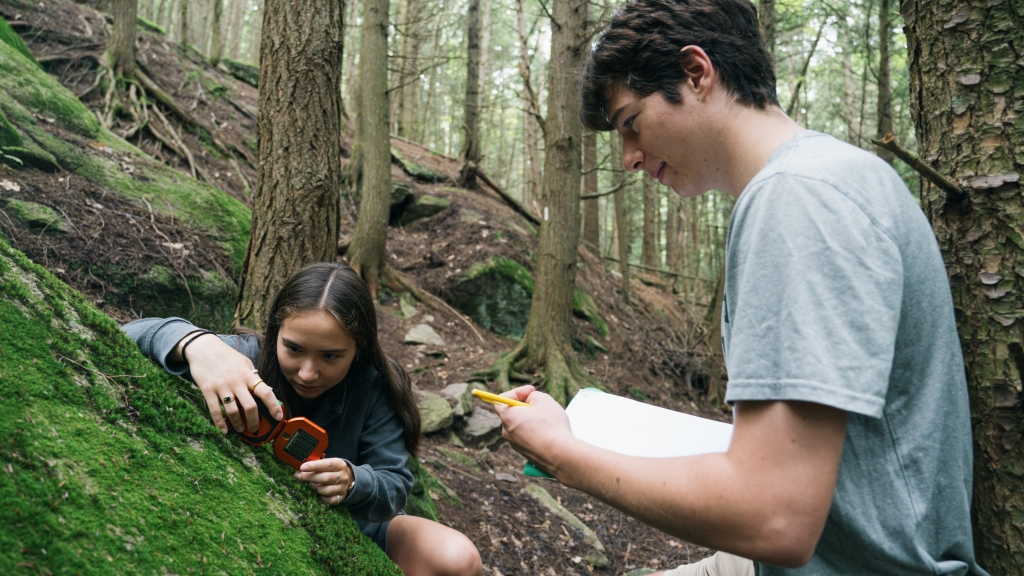 Students measuring rock formations